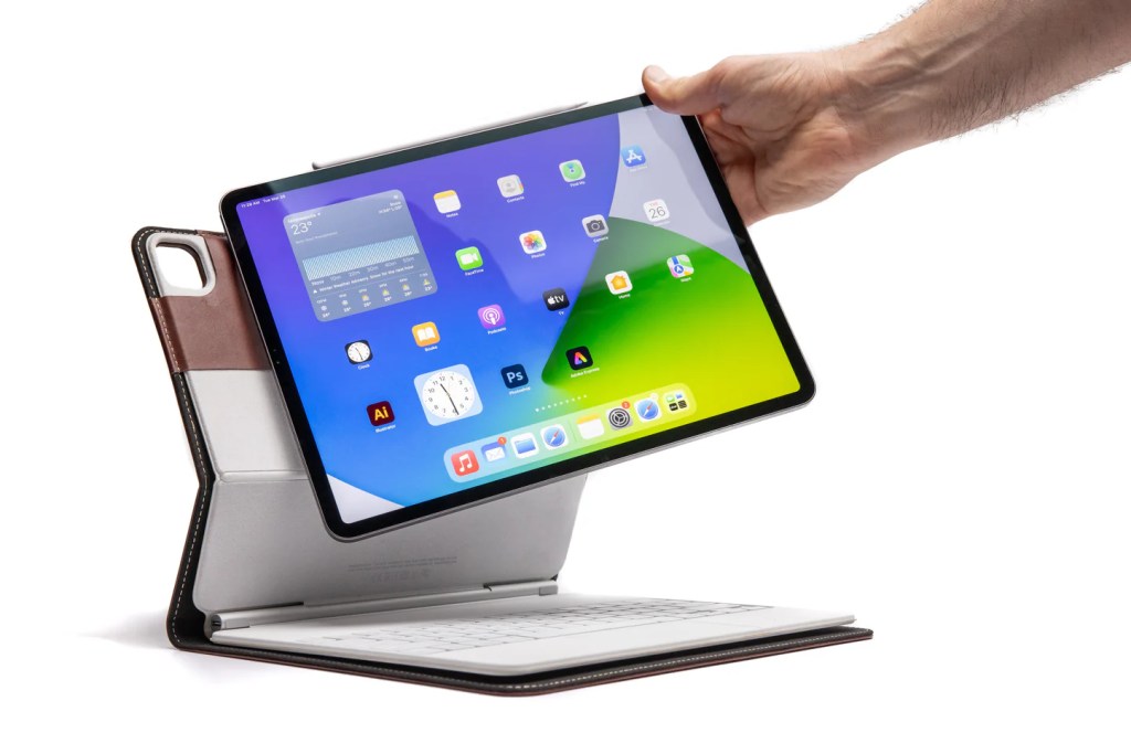 A hand holding a tablet