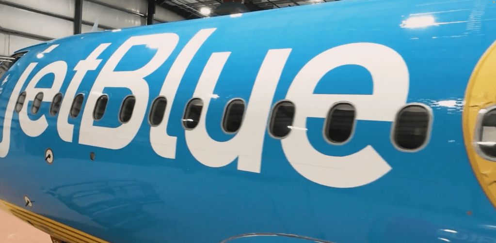 A blue airplane with white letters on it