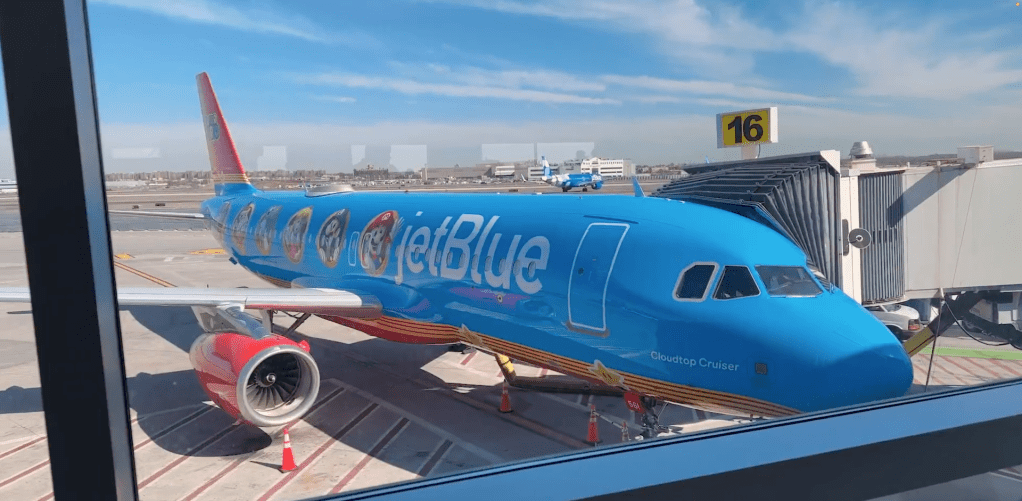 A blue airplane at an airport