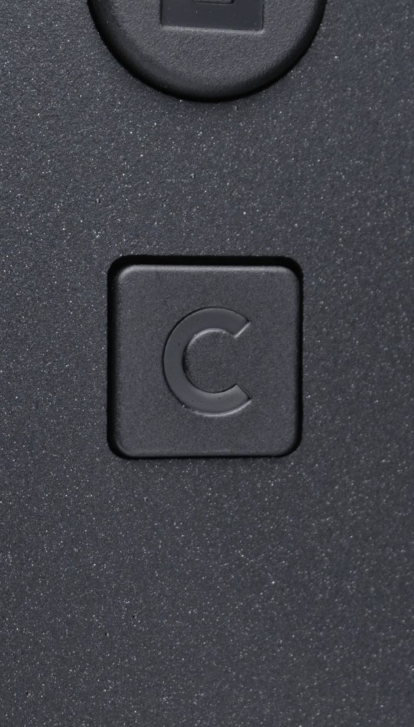 A square black button with a letter c