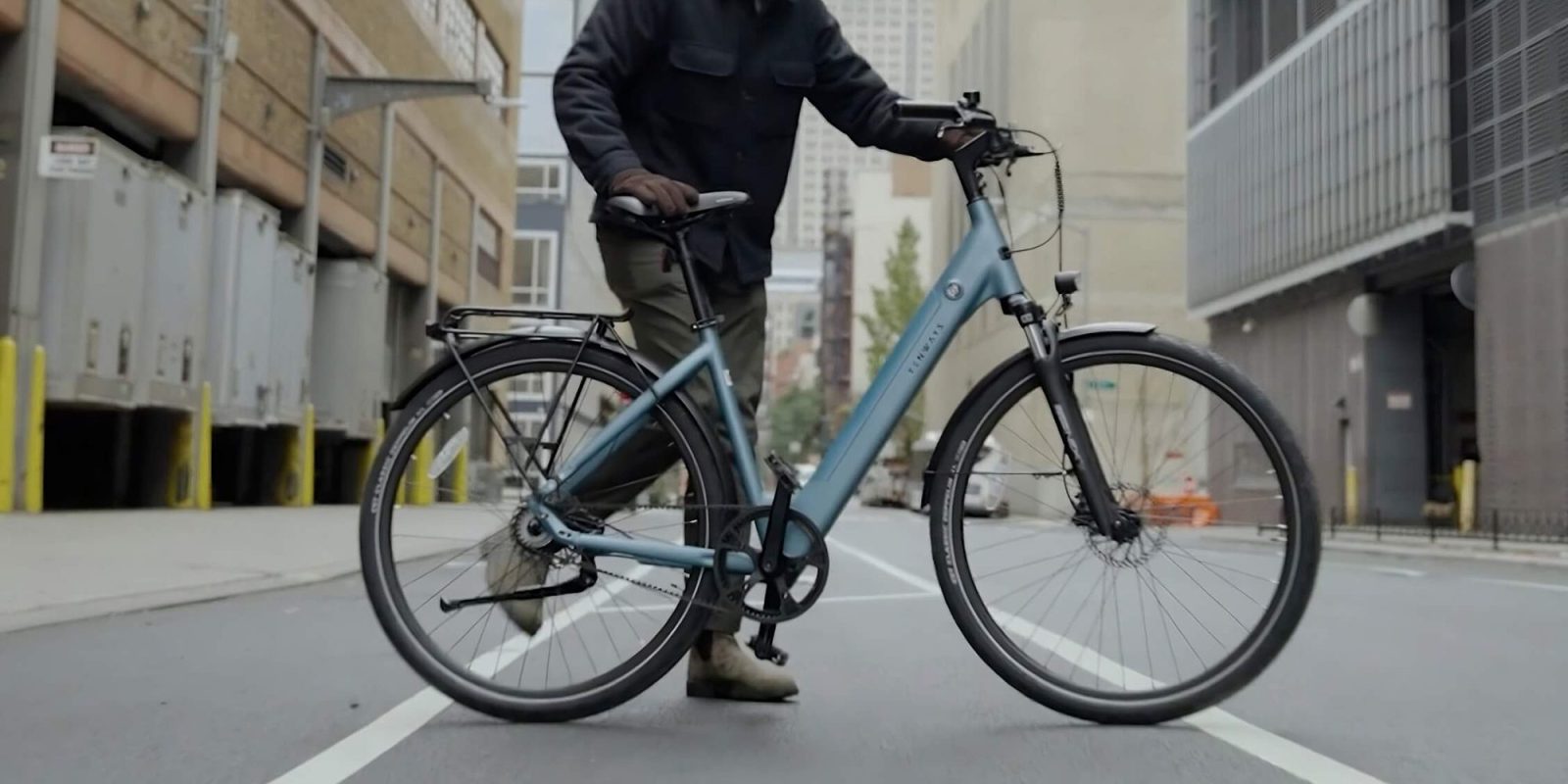 A man standing on a bicycle