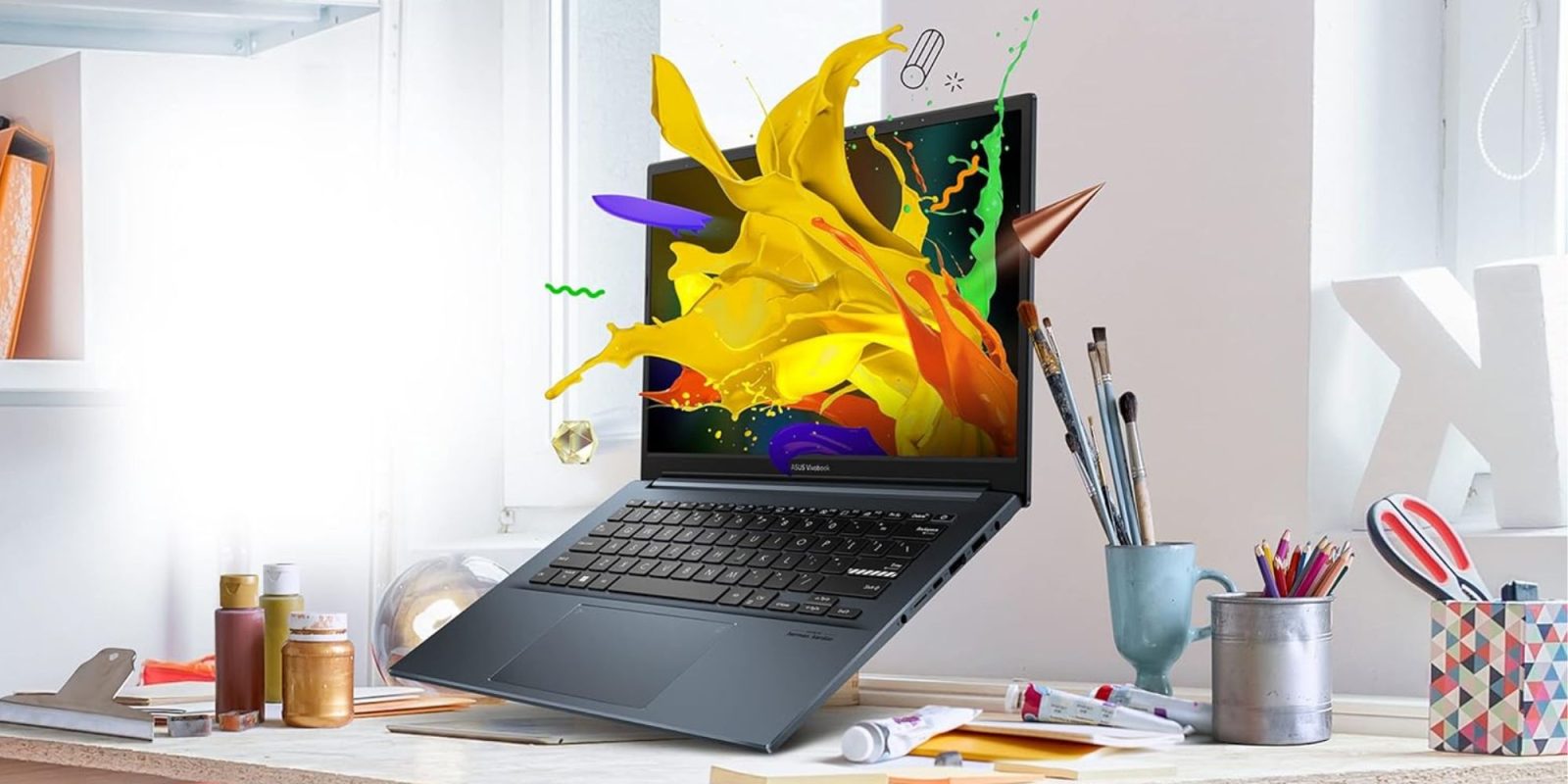 A laptop with paint splashing out of its display.