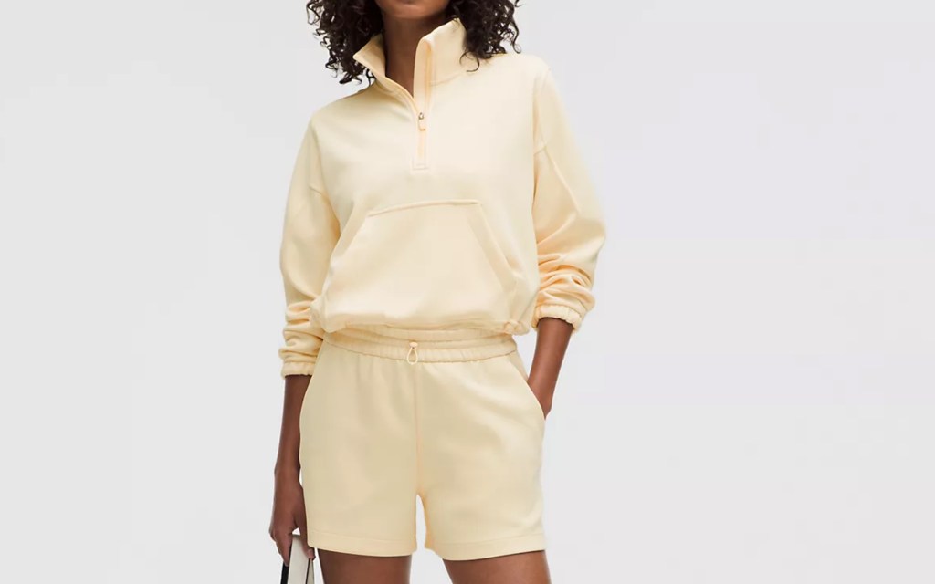 A woman in yellow shorts and a zip up jacket