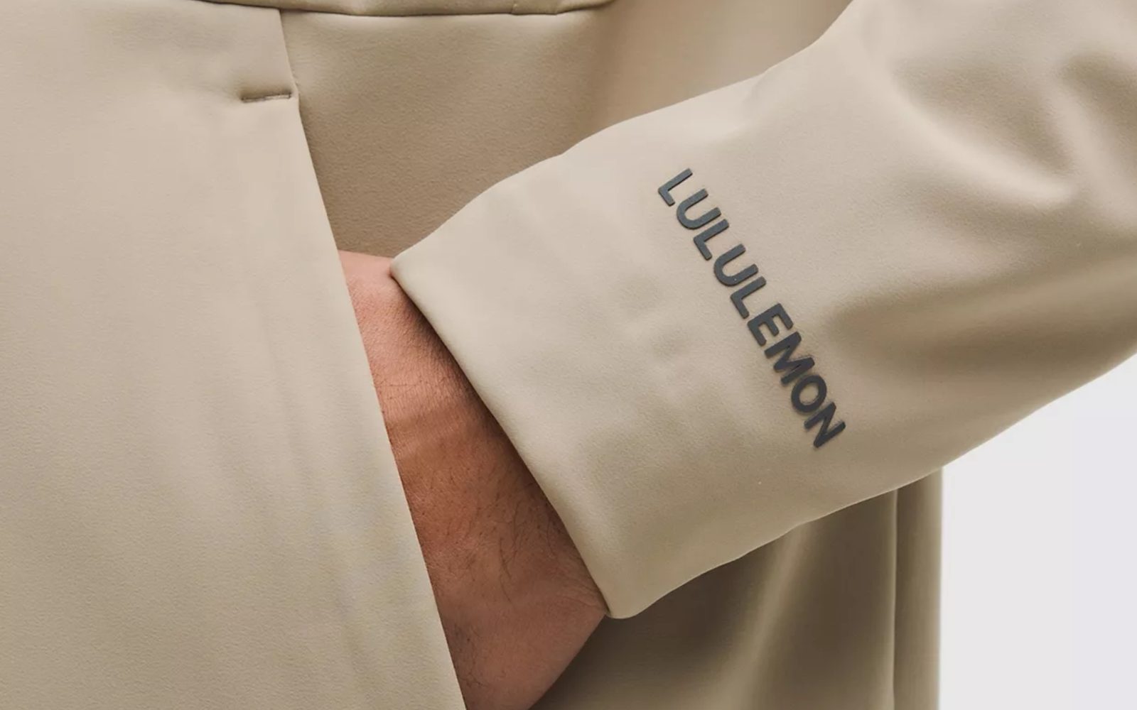 A person wearing a jacket with a name on the sleeve