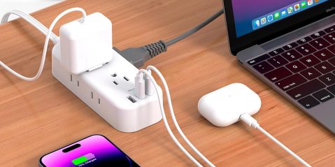 A power strip with plugs and a laptop