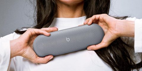 A person holding a speaker