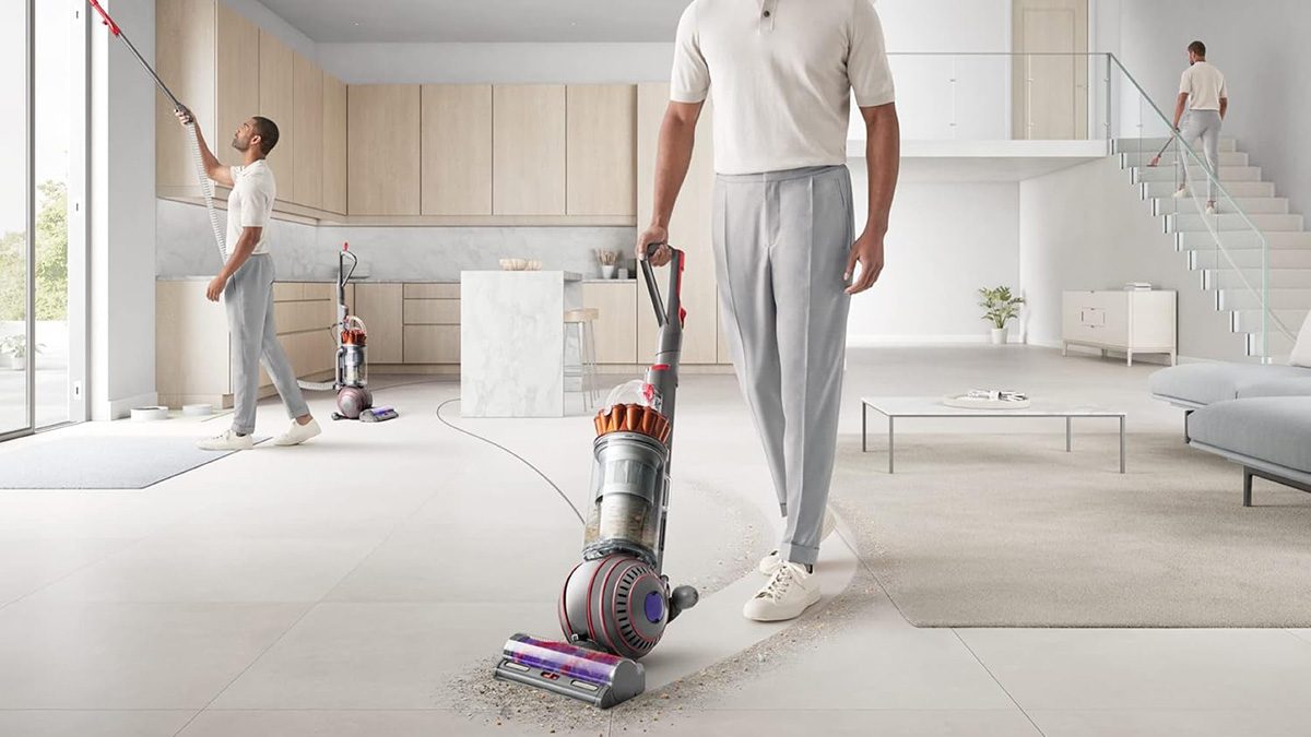 A man holding a vacuum cleaner