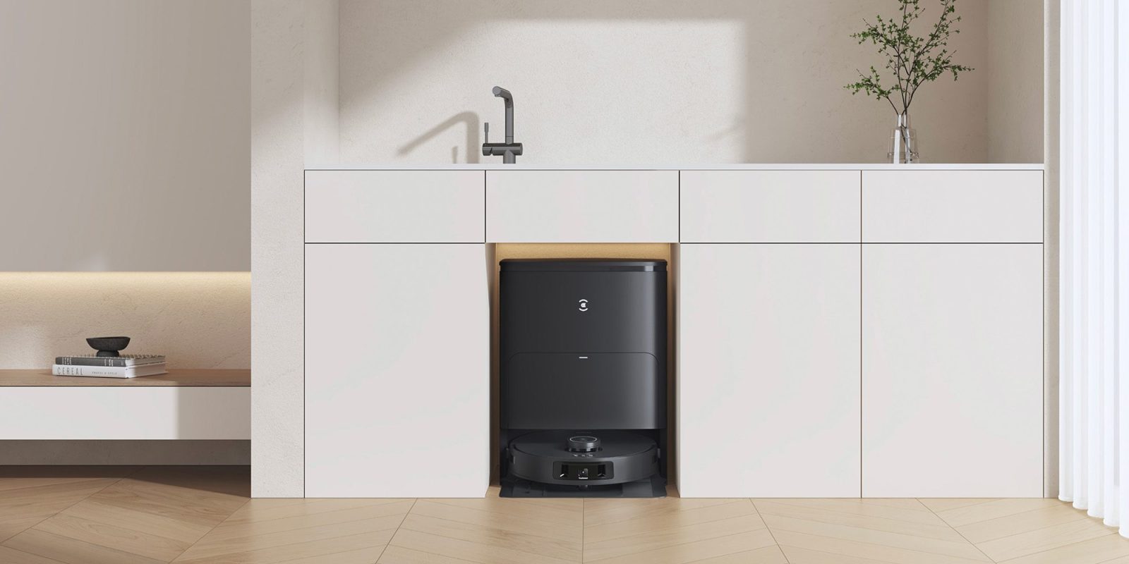 A black robot vacuum in a white kitchen