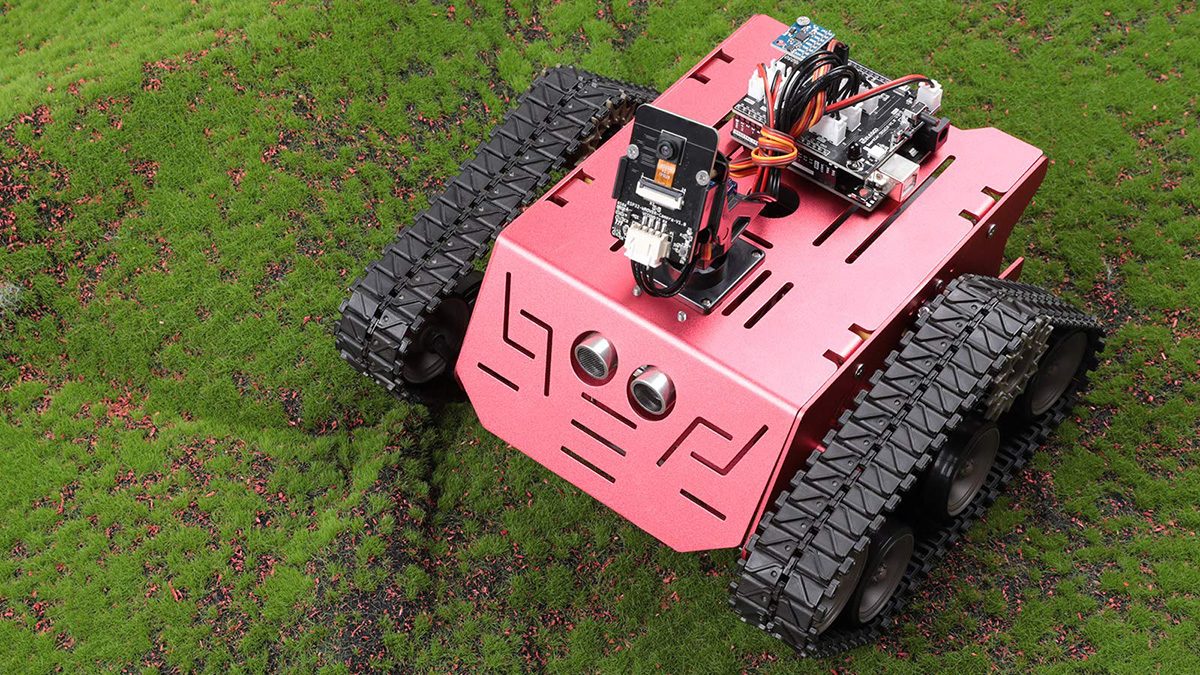 A pink robot with black wheels and wires