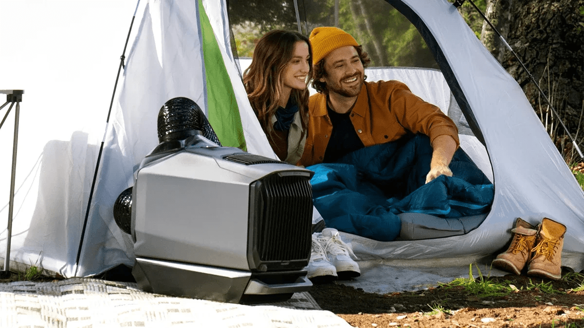 A man and woman sitting in a tent
