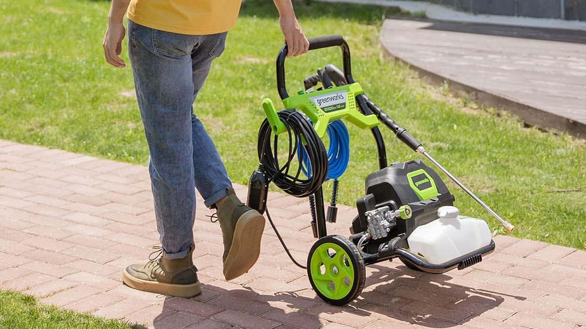 A person pushing a lawnmower