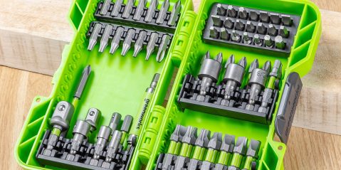 A green tool box with many bits in it