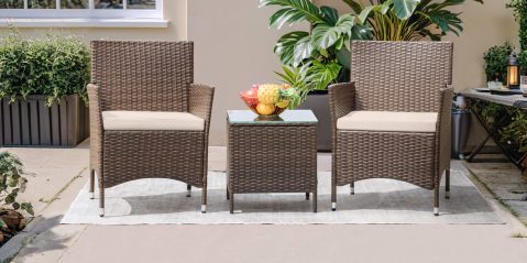 A wicker chairs and a table with fruit on it