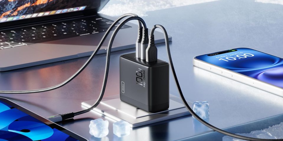 A black charger with wires connected to a laptop