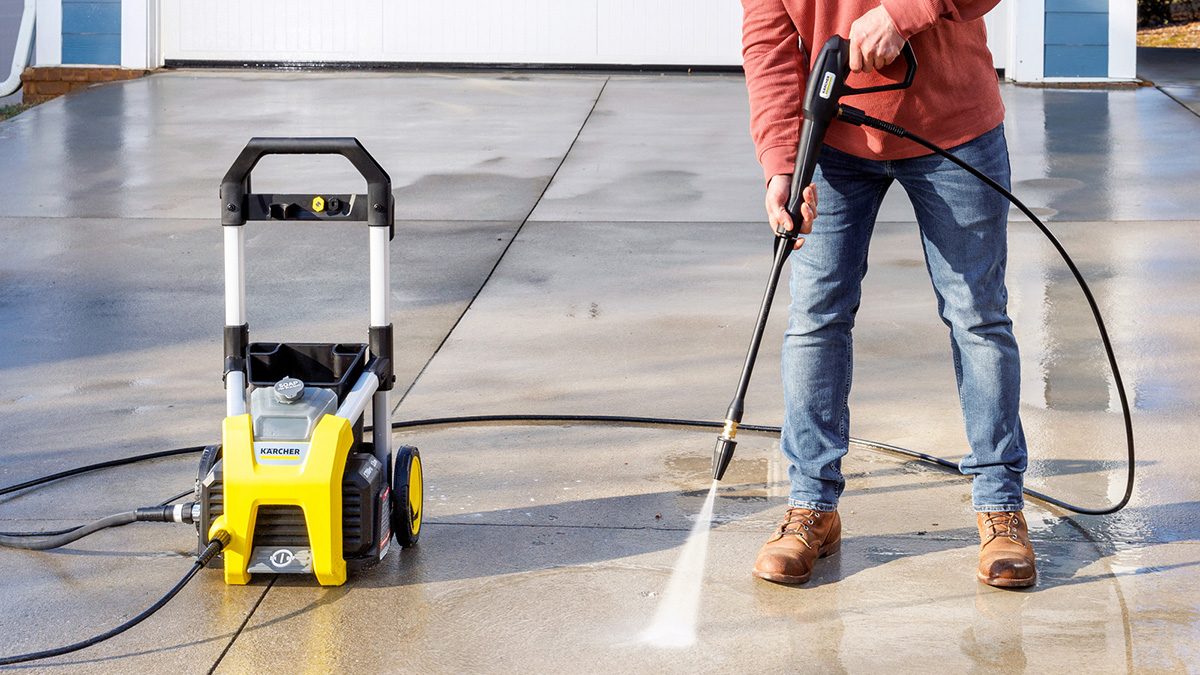 A person holding a power washer