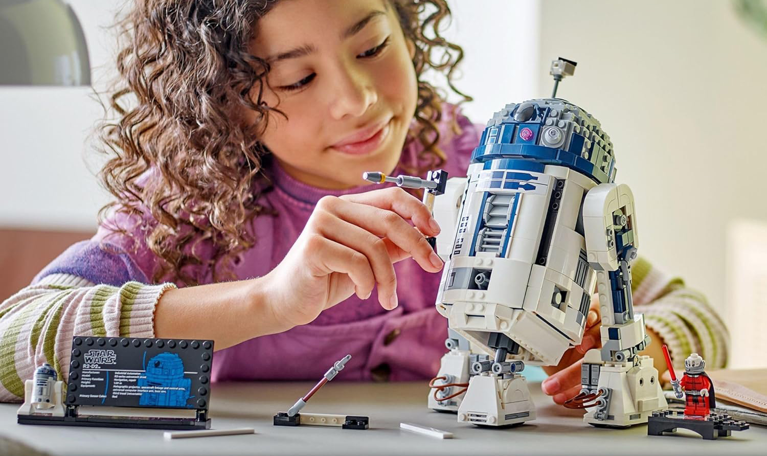 A girl building a robot