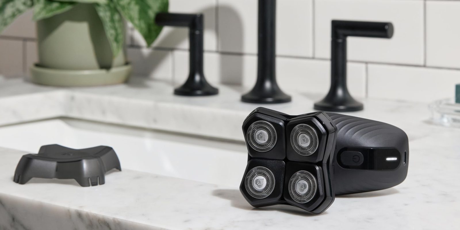 A black electric razor on a counter