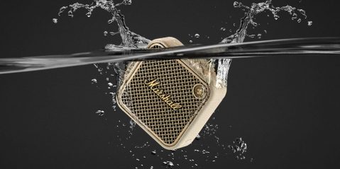 A speaker in water with a black background.