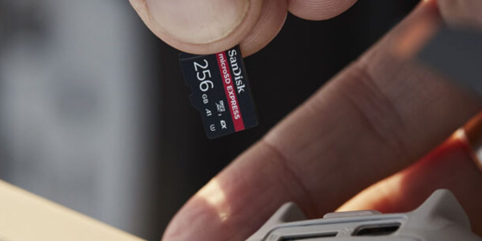 A hand holding a memory card