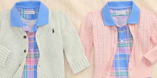 A couple of sweaters on a bed