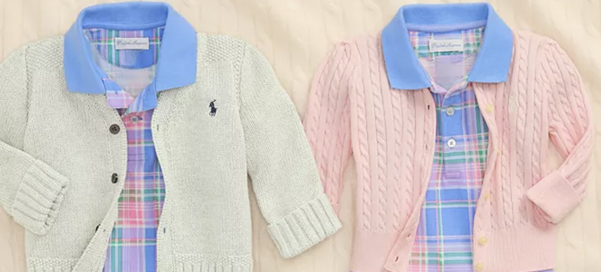 A couple of sweaters on a bed