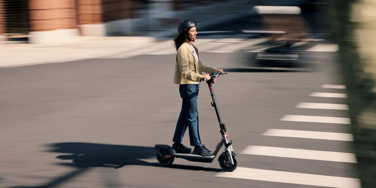 A woman riding a scooter