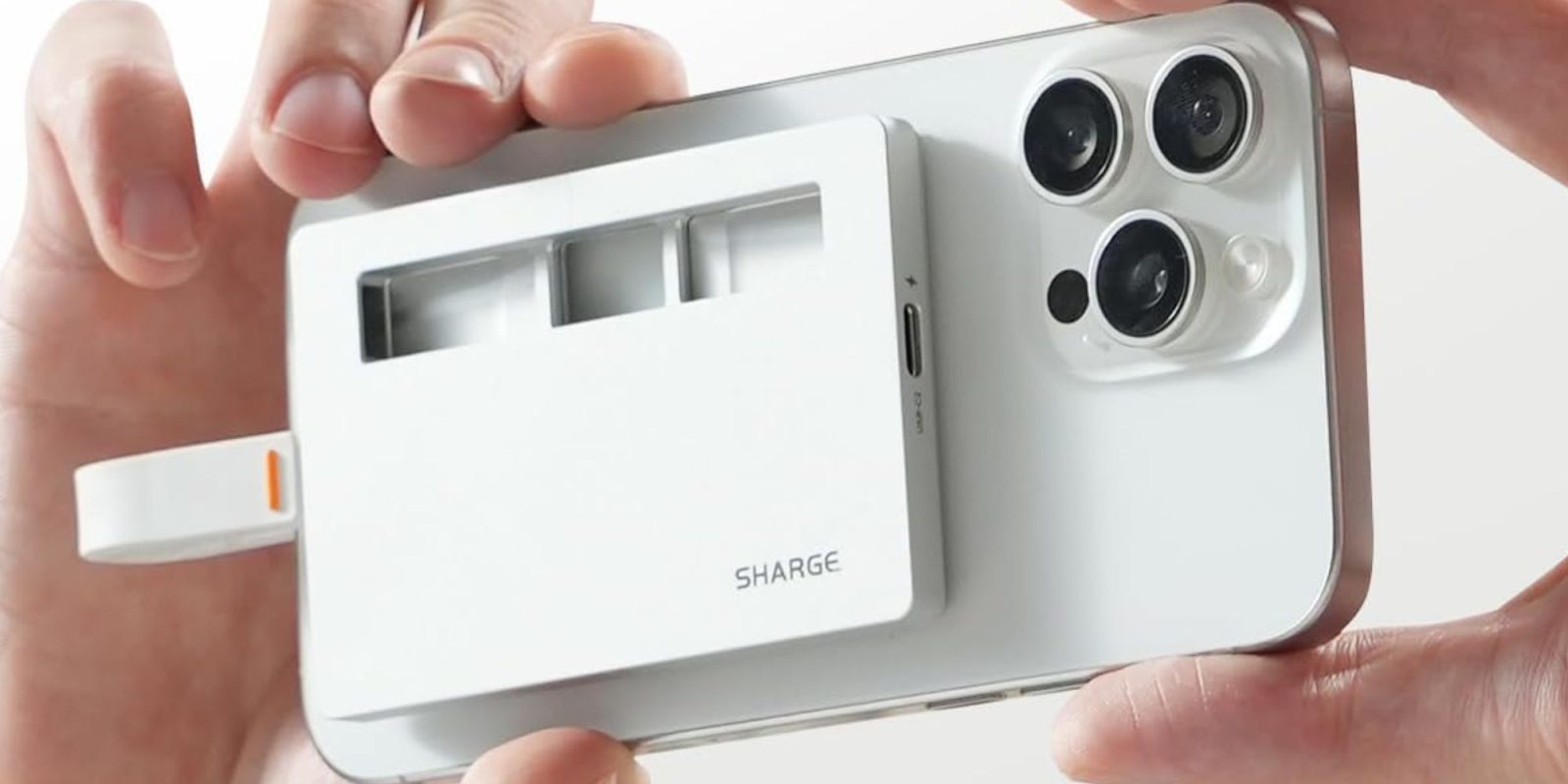 Image showing a person holding Sharge's Disk Plus SSD enclosure.