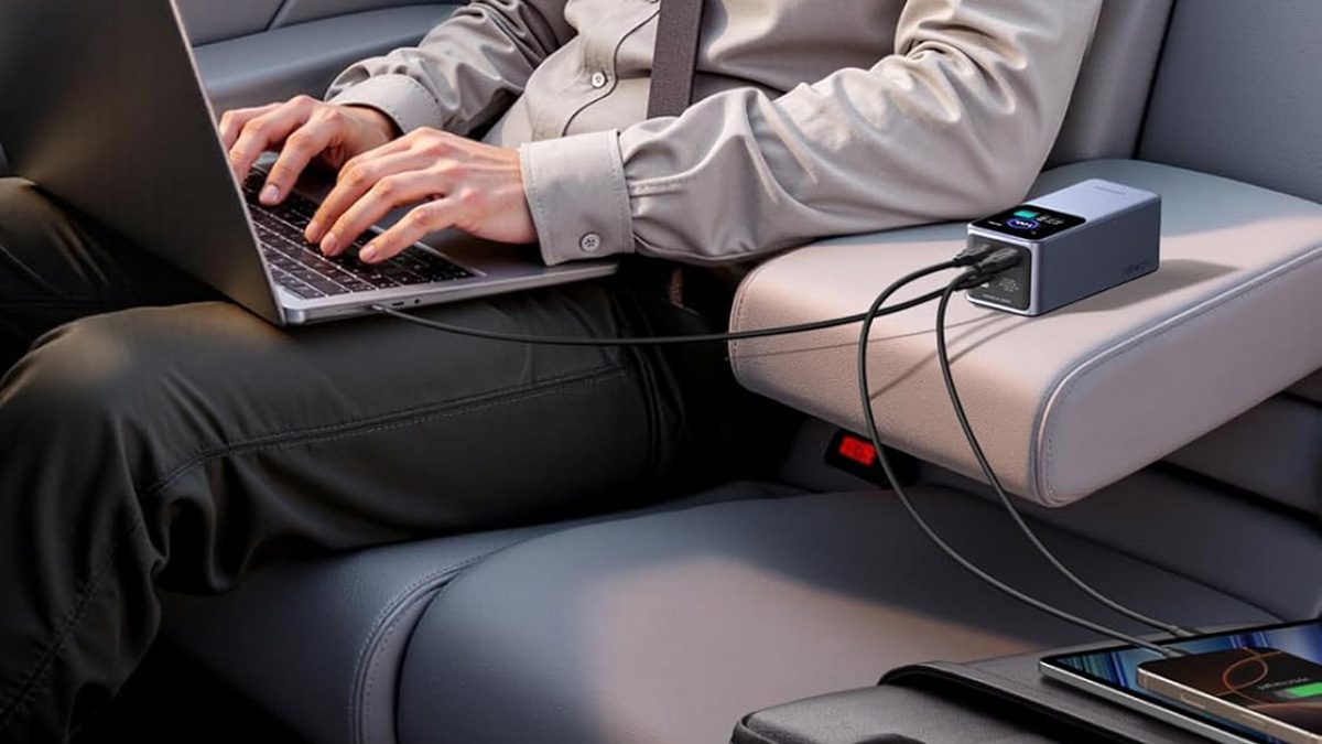 A person sitting in a car using a laptop