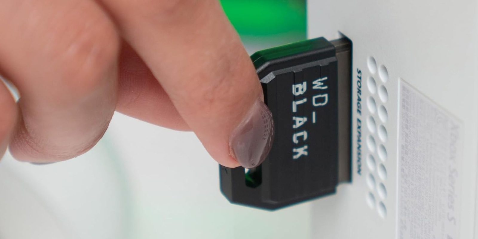 Image showing a person inserting WD's C50 Expansion card.