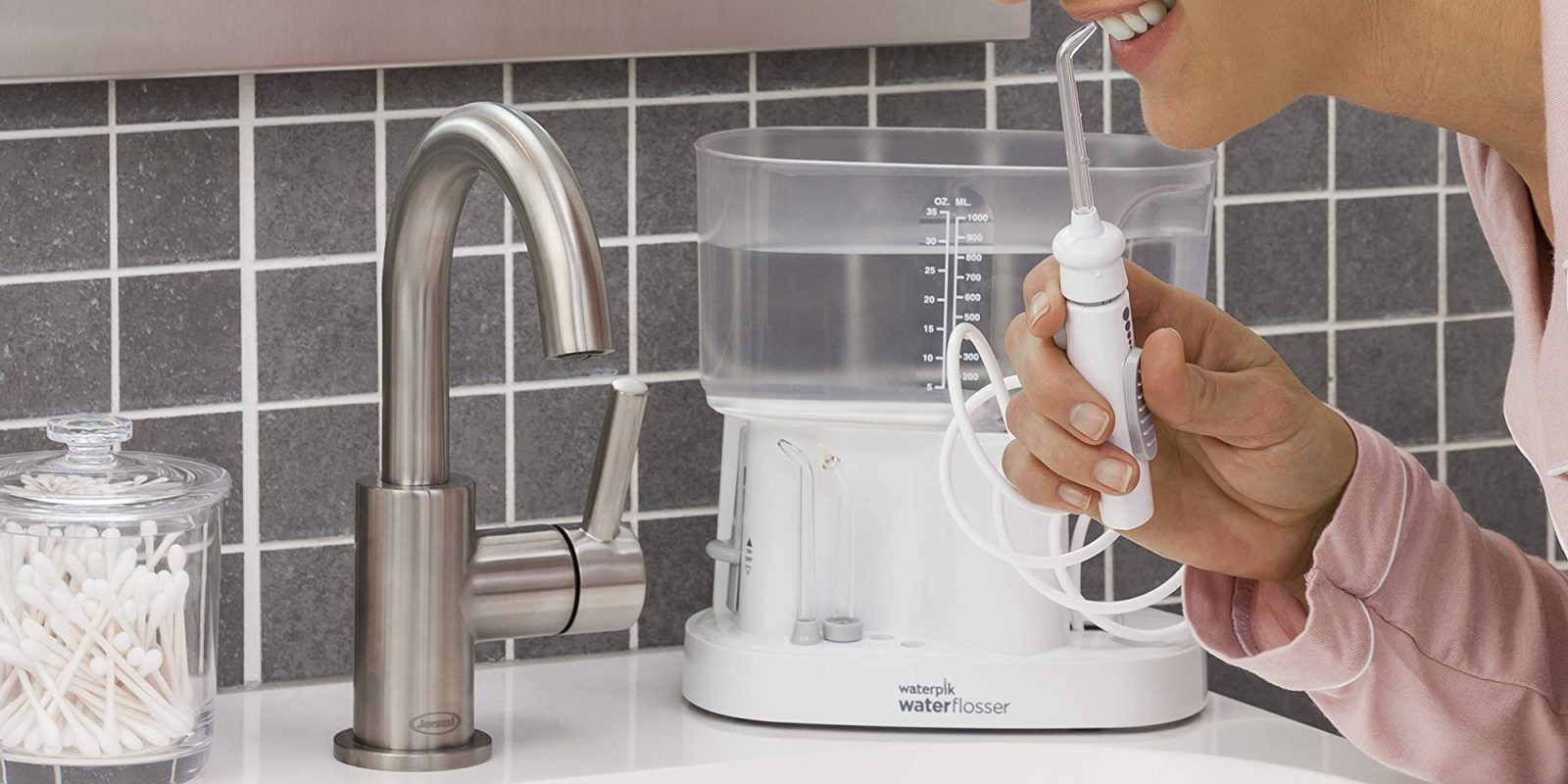 A person holding a water flosser