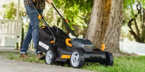 A person pushing a lawnmower