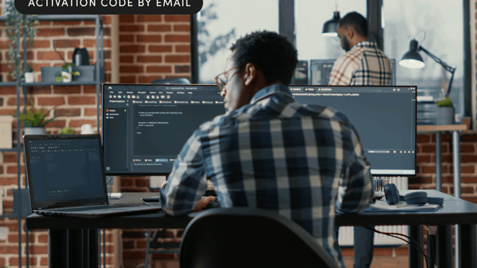 A man sitting at a desk with a computer