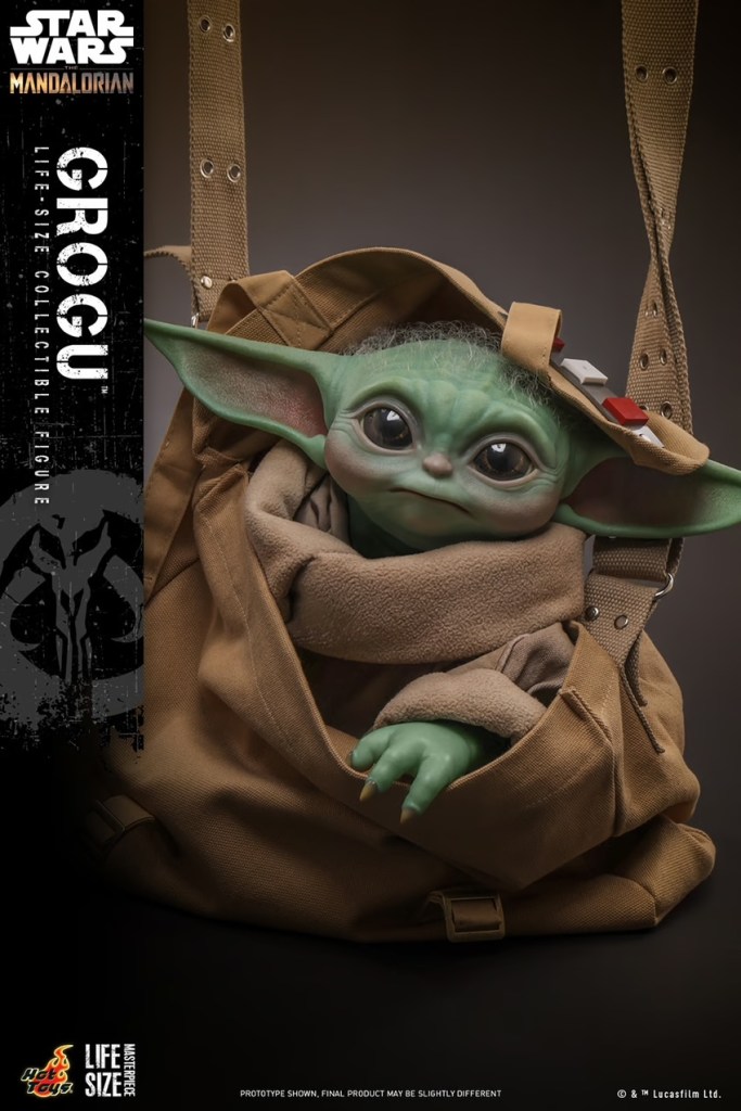 A toy baby yoda in a bag