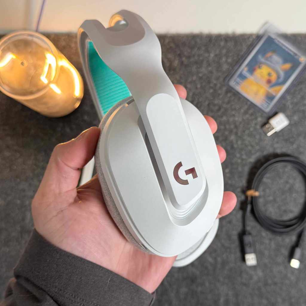 A hand holding a headphone