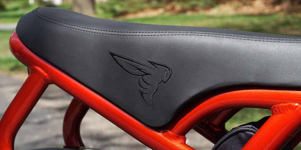 A black seat with a logo on it