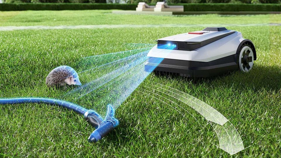 A hedgehog on grass with a vacuum cleaner