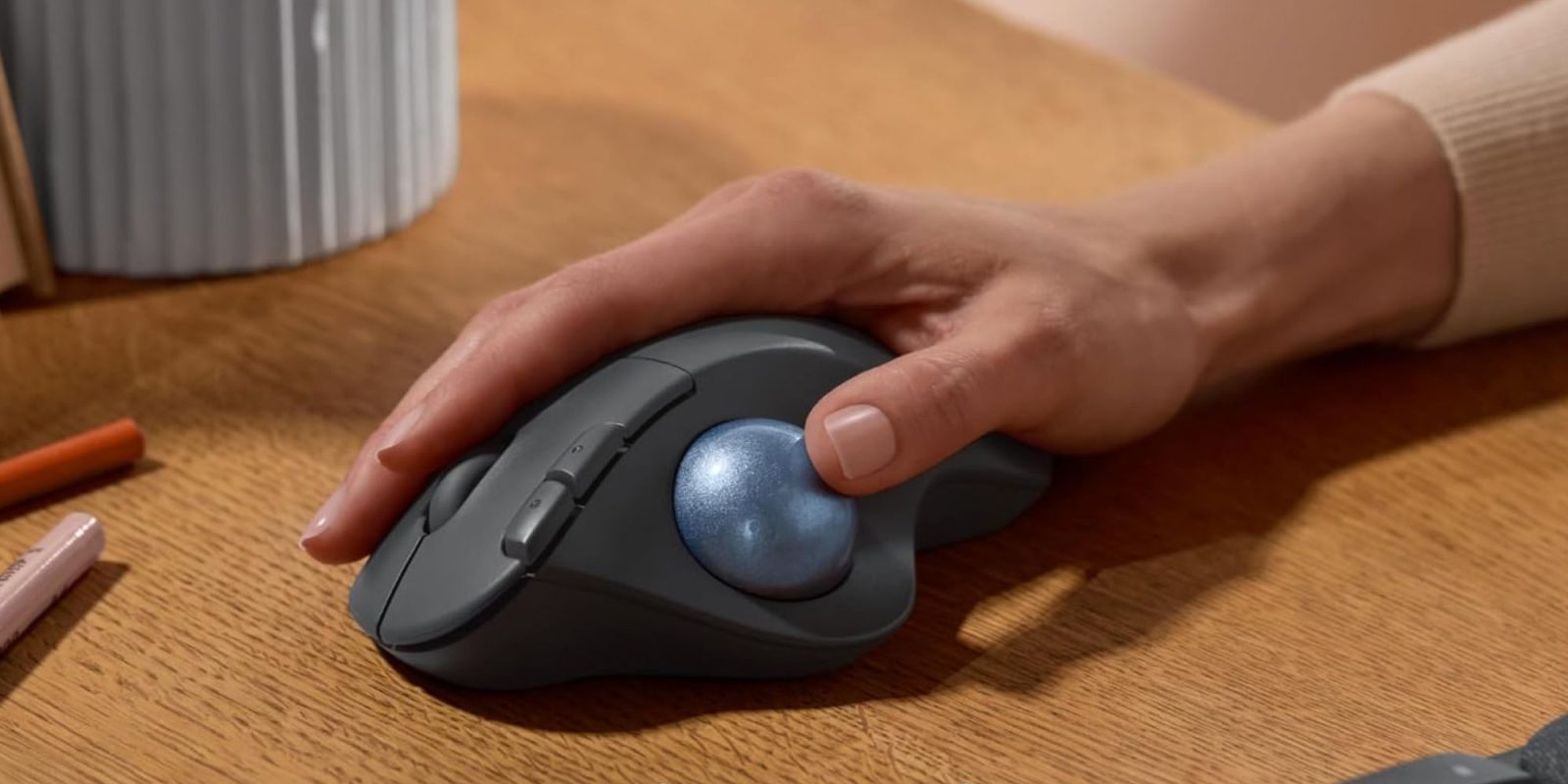 Image showing a person holding Logitech's Ergo M575S trackball mouse.