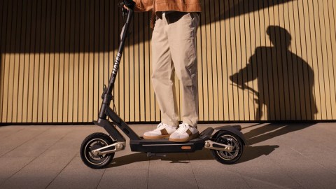 A person standing on a scooter
