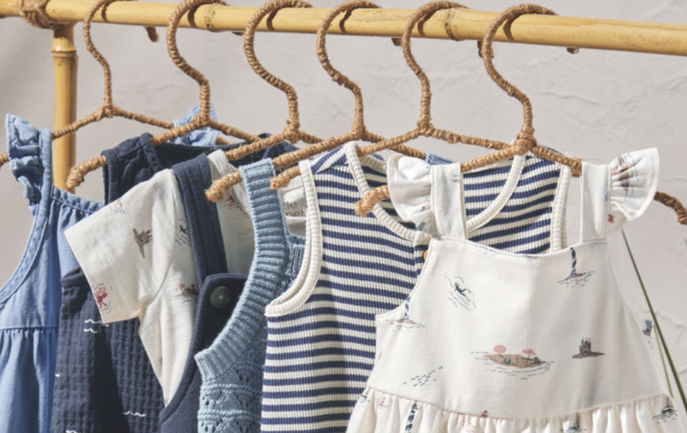 A group of baby clothes on swingers