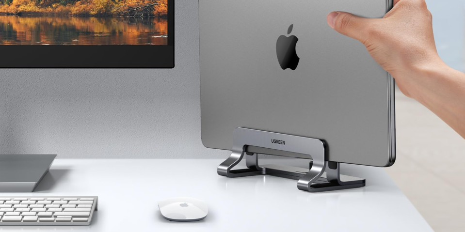 A hand pointing at a computer monitor