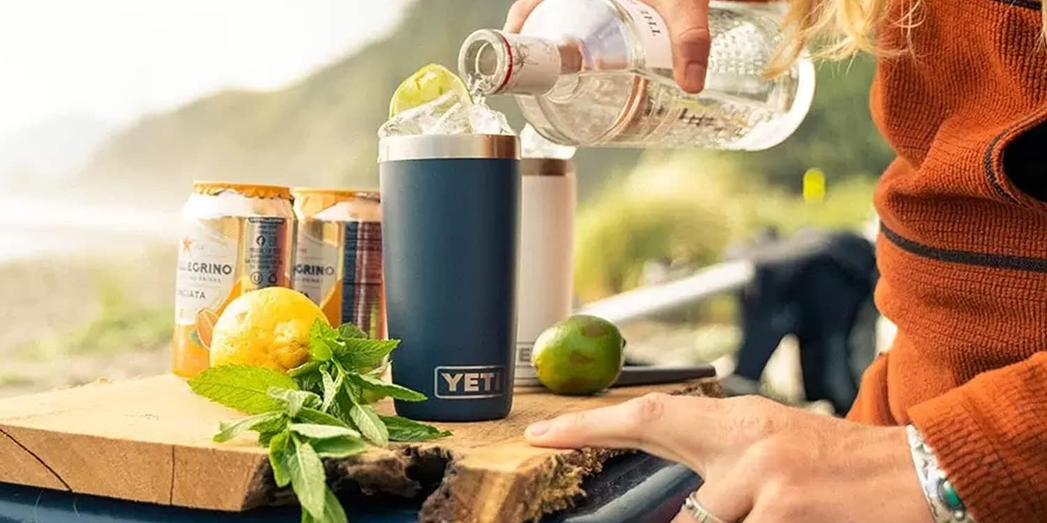 A person pouring a drink into a cup