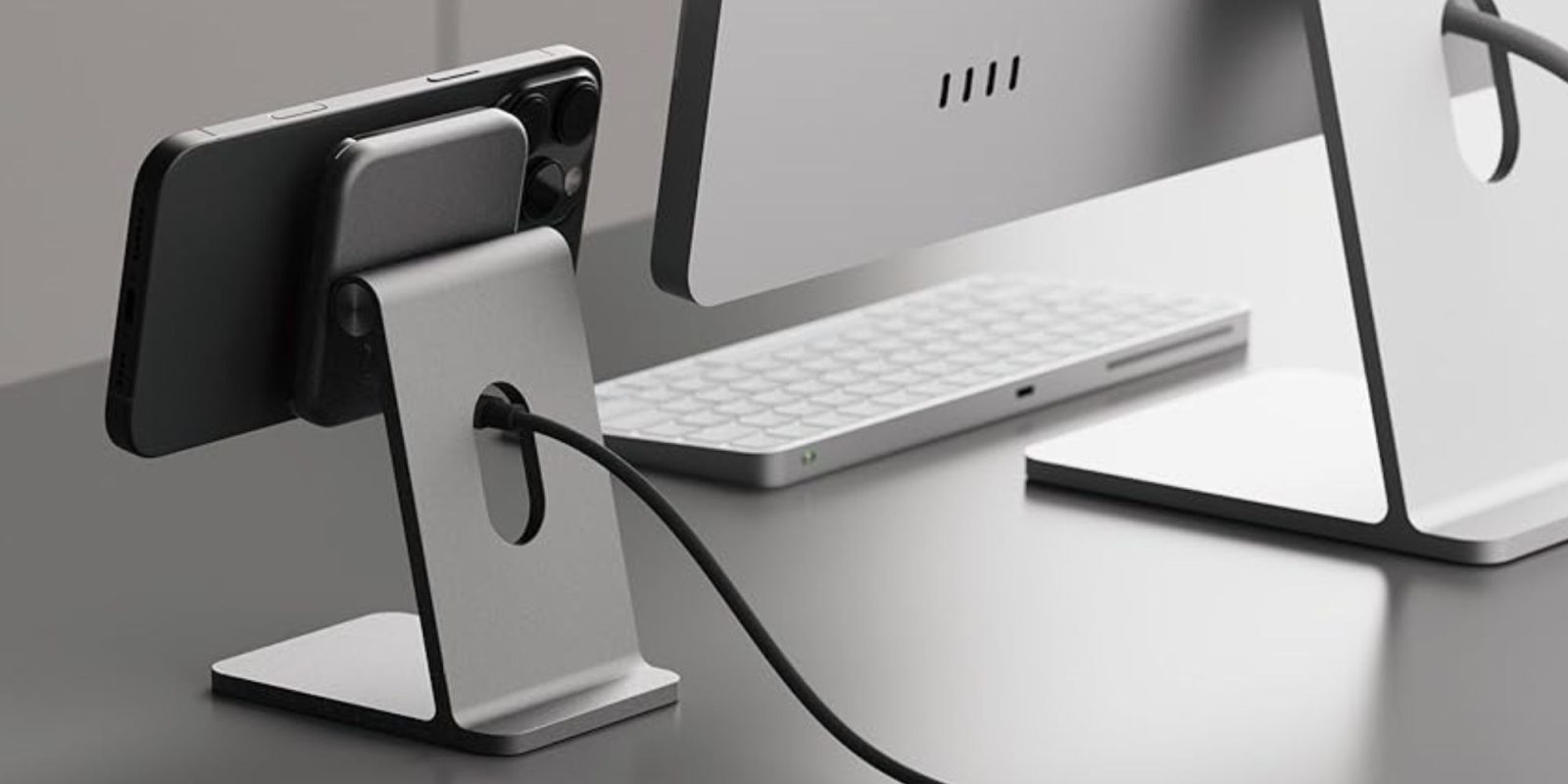 Image showing an iPhone charging on an aluminum MagSafe charger.