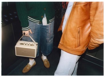 A person holding a small white radio