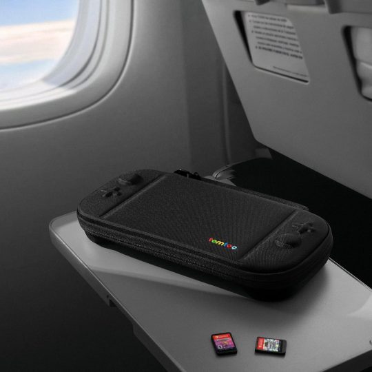 A black case on a table next to a small device
