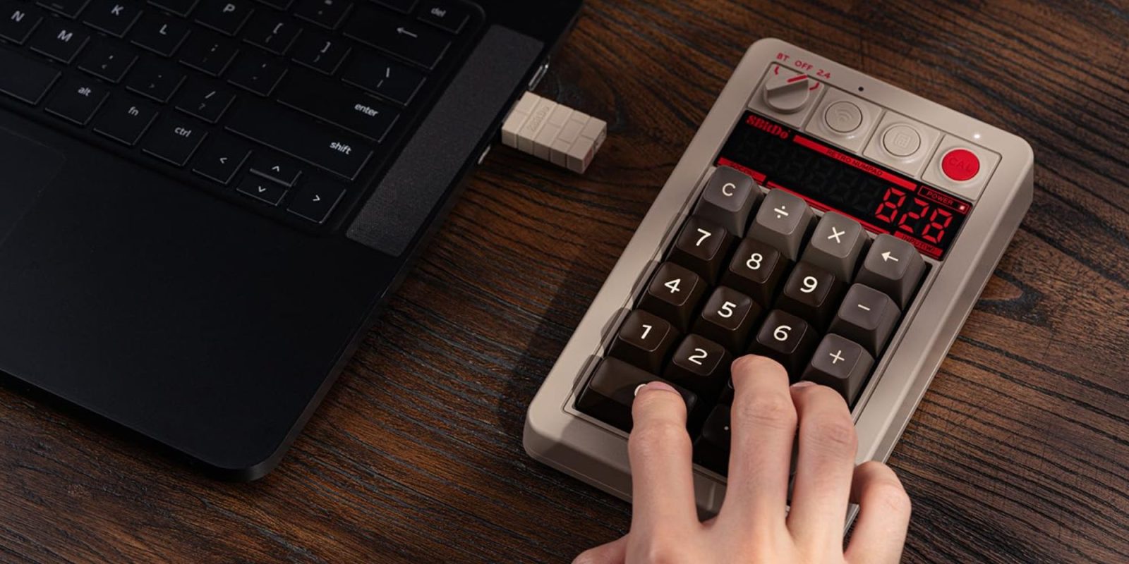 Image showing a person using 8Bitdo's Retro 18 C64 Edition numpad.