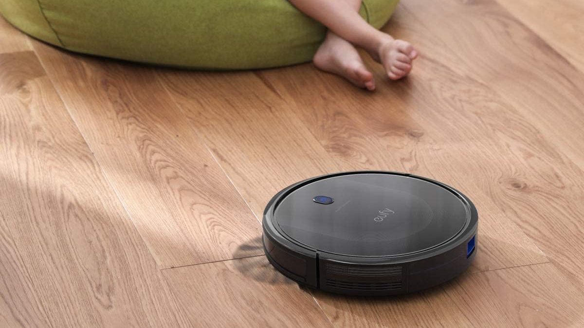 A robot vacuum cleaner on a wood floor