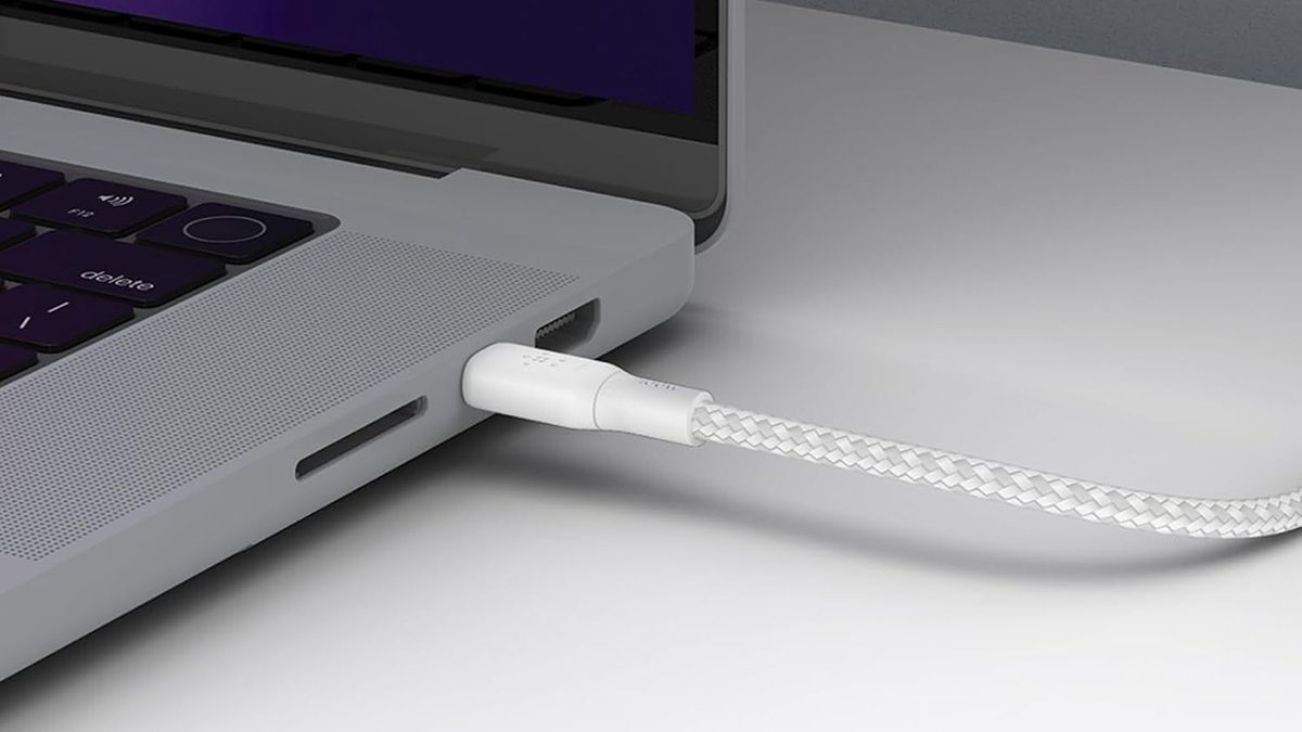 A white cable plugged into a laptop