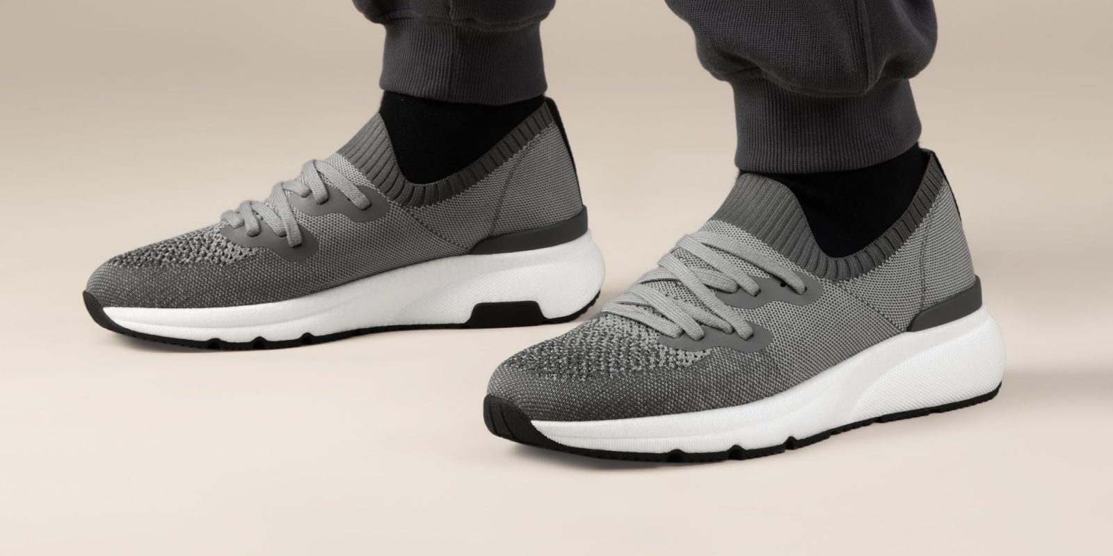 A person wearing grey and white shoes