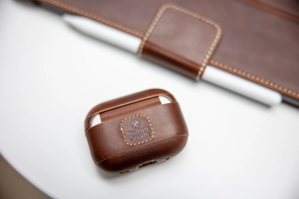 A brown leather case with a pen