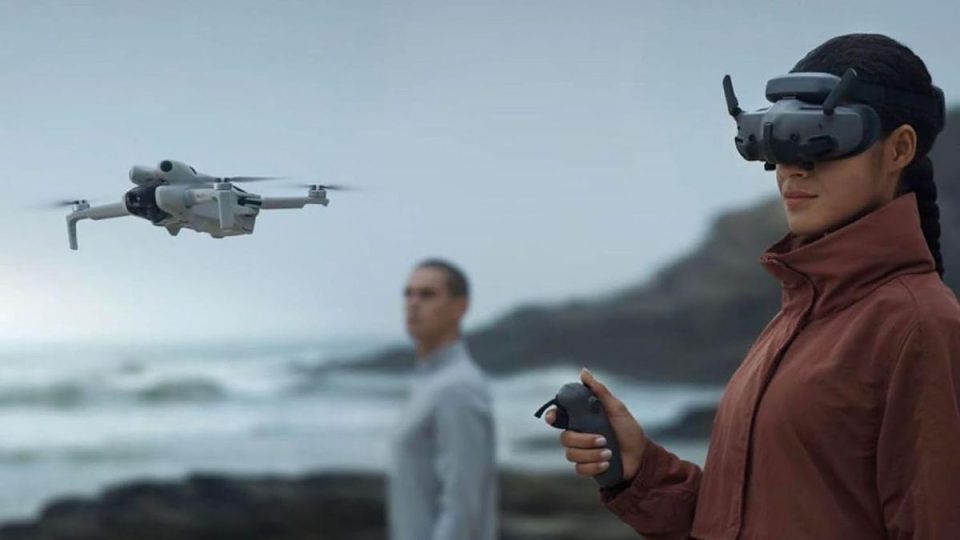 A woman holding a remote control and a man in the background